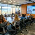 a dynamic training session in a sleek, modern conference room showcases executives engaged in a vibrant discussion, emphasizing resilience and leadership development through interactive learning.